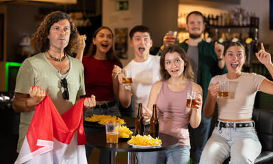 Fans of the Netherlands national team spend time in a bar, shouting chants, supporting their favorite team