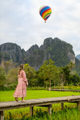 Woman, rice paddy, hot air balloon