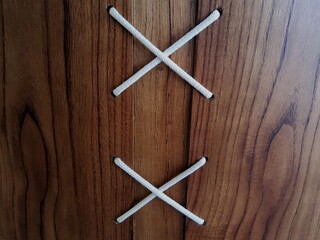 Wooden background with X in rope