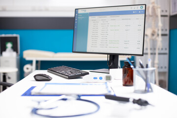 Clinical office with essential healthcare tool and medical data shown on computer screen ready for...