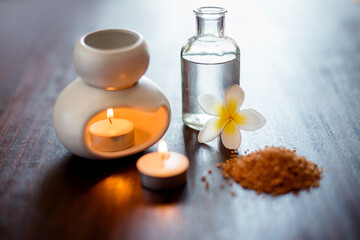 Flower, spa and aromatherapy candle on table with incense, peace and natural fragrance. Holistic health, hospitality service and powder with essential oil for self care at luxury wellness salon