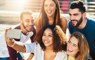 Obraz premium Happy people, friends and city with selfie for picture, photography or holiday memory together. Excited, group or community with smile for friendship weekend, capture moment or post in an urban town