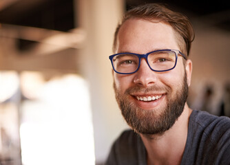 Glasses, happy and portrait of man in coffee shop for digital nomad career with travel for...