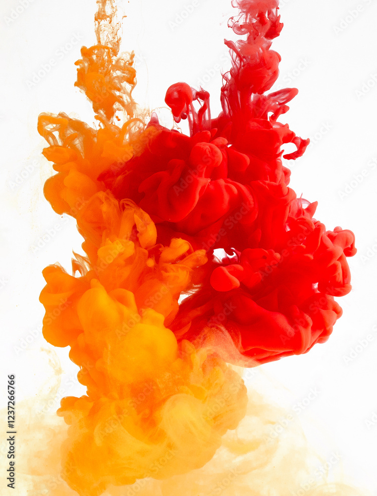 Leinwandbilder yellow and red ink in water creating abstract shape, isolated on white background