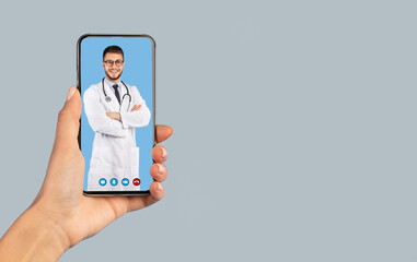 Medical Application. Female Hand Holding Smartphone With Male Doctor On Phone Screen Smiling To Camera Wearing White Uniform On Blue Studio Background. Distance Consultation. Vertical, Collage