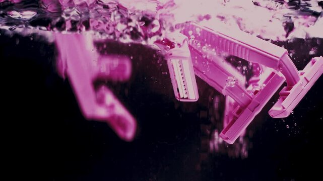 Pink Razers Fall in Water in Slow Motion