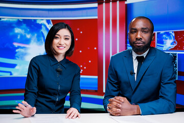 News anchor team on morning show discussing about daily headlines and providing important information for exclusive tv content. Diverse broadcasters meeting in newsroom to debate issues.