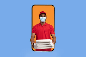 Food Delivery App. African american courier in mobile phone screen holding pizza boxes wearing face mask, delivering meal from restaurant and giving it to camera, yellow background. Square