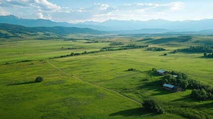 Aerial View of Serene Green Field and Mountain Range