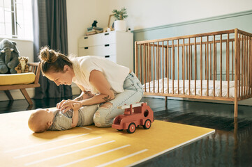 Love, bonding or mother playing with baby in nursery, having fun or enjoy relax quality time...