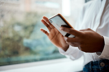 Office, hands and person with smartphone for chat, online communication and text for contact. Window, business designer and scroll with mobile for message, application and digital on social media