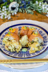 Lobster tempura sushi with avocado and ginger with chopsticks