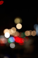 Fototapeta premium Evening city lights create a vibrant atmosphere with blurred colors and shapes in an urban environment