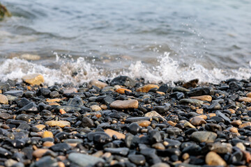 Scenery of a pebble beach with gentle waves hitting Geoje Island, Korea