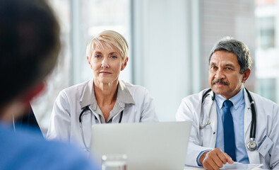 Doctor, laptop and meeting with team for interview, discussion or hiring process at hospital....