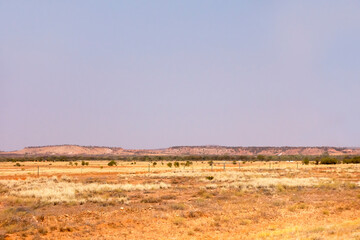 Arid outback airfield with windsock near Stuarts Well in the Northern Territory of Australia with small hills in the background.