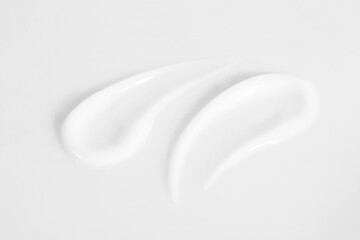 Smears of cosmetic product on white background, closeup