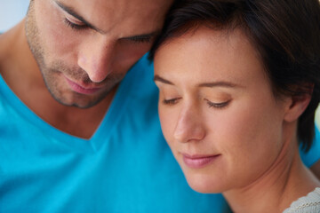 Love, couple and forehead touch for support, care and bonding together for commitment to serious relationship. Man, woman and comfort partner in marriage, romantic connection and loyalty in home