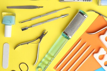 Set of pedicure tools on color background, flat lay