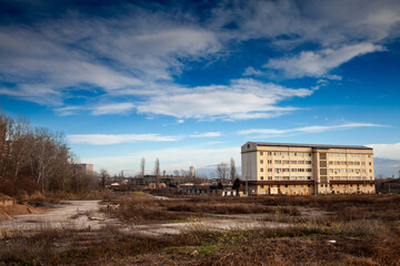 Abandoned factories and warehouses, remnants of a bygone industrial era, stand vacant amid...