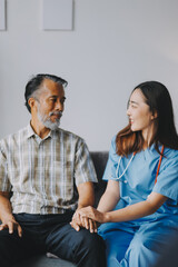 Doctor holding hands of patient at hospital.