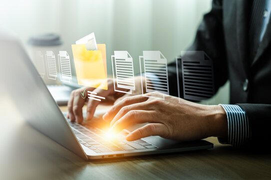 Businessman Organizing Digital Documents with Virtual File Management System on Laptop, Highlighting Efficient Workflow, Data Organization, and Modern Technology for Professional Productivity