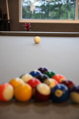Pool balls lined up to be broken on a billiards table