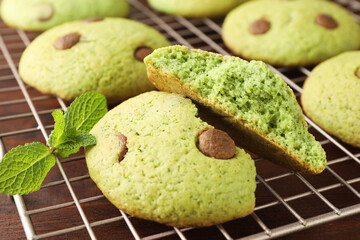Delicious mint chocolate chip cookies on wooden table, closeup