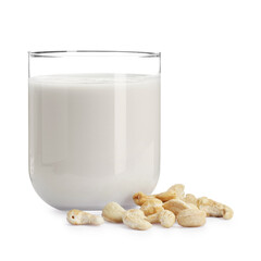 Fresh cashew milk in glass and nuts isolated on white