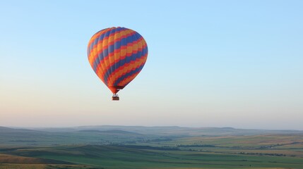 Fototapeta premium Hot air balloon soaring over serene countryside at dawn; travel, adventure