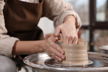 Hobby and craft. Woman making pottery indoors, closeup