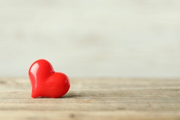 Fototapeta premium Red decorative heart on wooden table, space for text. Happy Valentine's day