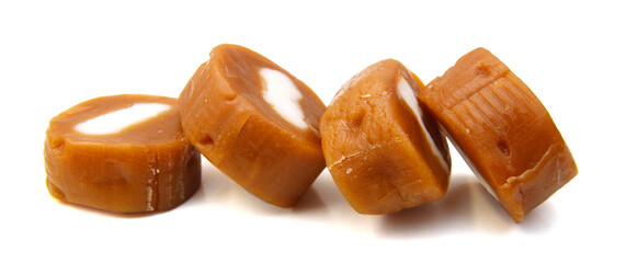 Caramel candies isolated on white background