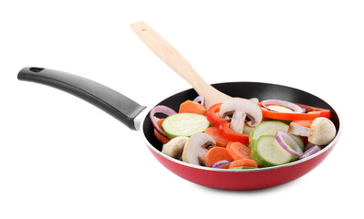 Frying pan with mix of fresh vegetables, mushrooms and spatula isolated on white