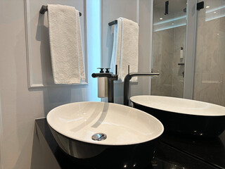 Stylish sink near mirror in hotel bathroom
