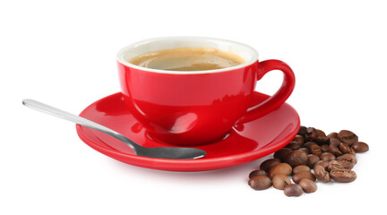 Red cup of aromatic coffee, saucer, spoon and beans isolated on white