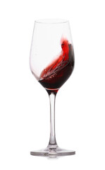 Red wine splashing in glass on white background