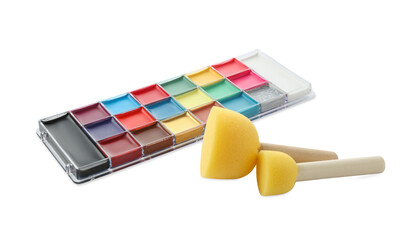 Bright face paint palette and sponges isolated on white