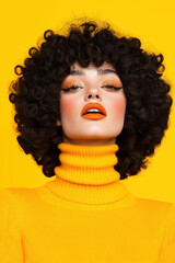 Portrait of a woman with curly hair and orange makeup on a yellow background