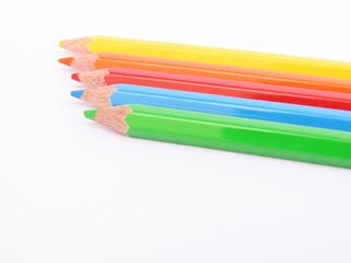 Fototapeta premium Colored pencils on white background. Blue, green, red, orange and yellow colored pencils.