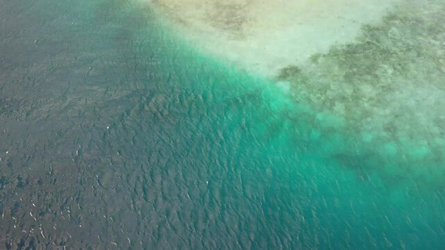 Punta madrisky, los roques with vibrant blue and turquoise waters, aerial view