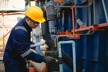 A plumbing inspector is inspecting the operation of a high-pressure water pump system in an...