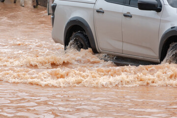Muddy rain from a heavy rainy season flooded main roads connecting the district, making it...