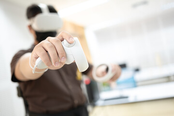 Person using a VR headset and controllers, engaging in an immersive virtual reality experience in a...
