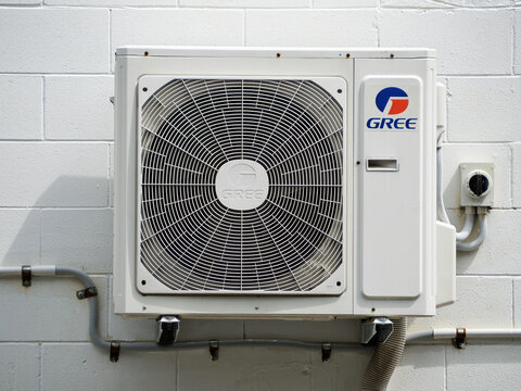 Gree Air Conditioning Unit Mounted at Exterior White Brick Wall