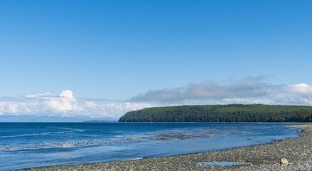 panorama view from the shore of Malcolm Island beautiful water of the ocean with clouds on blue sky