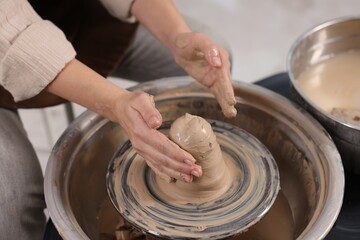 Hobby and craft. Woman making pottery indoors, closeup