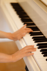 Fototapeta premium Lady playing piano with selective focus and shallow depth of field. High quality photo