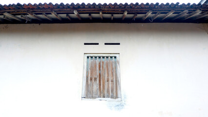 traditional classic windows made of wood and wooden dividers under a tile roof from Java, Indonesia