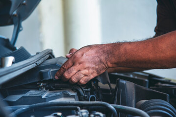 Close up Man hands fixing Car machinery vehicle mechanical service. Mechanic man hands repairing car auto repair shop. open vehicle hood checking up auto mobile. Vehicle Car maintenance engineer.